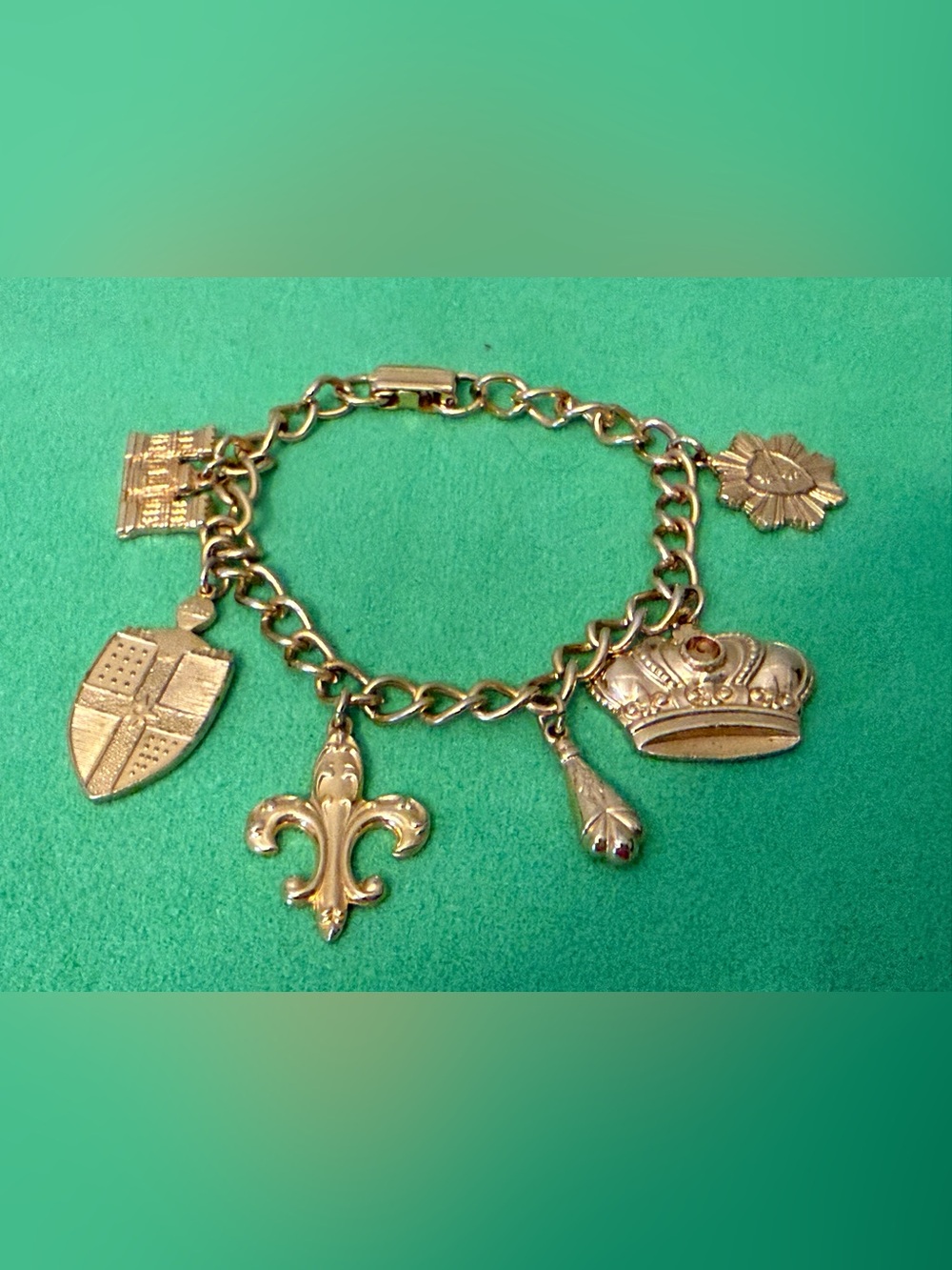 Vintage Gold-Tone Charm Bracelet with Crown, Fleur-de-Lis and Shield Charms